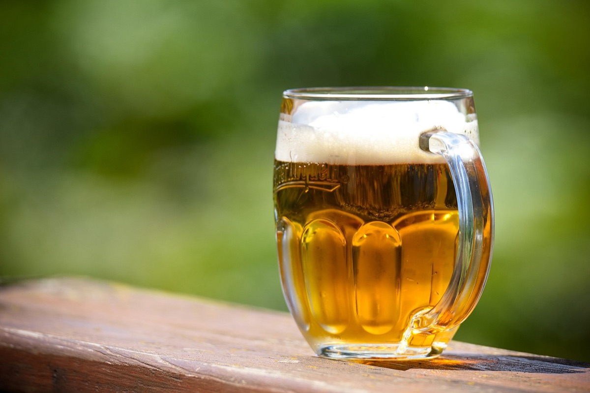 Beer can with foam and glass