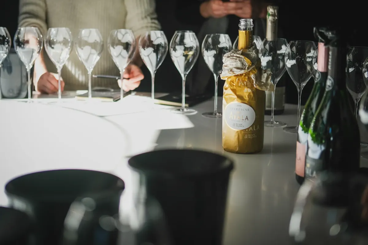 Chic champagne tasting with wine glasses and bottles in Aÿ, Grand Est, France.